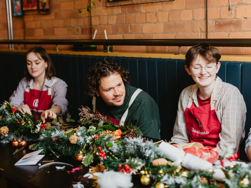 group making Christmas wreaths